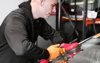 Certified technician performing auto glass replacement on a car in Georgetown, Texas