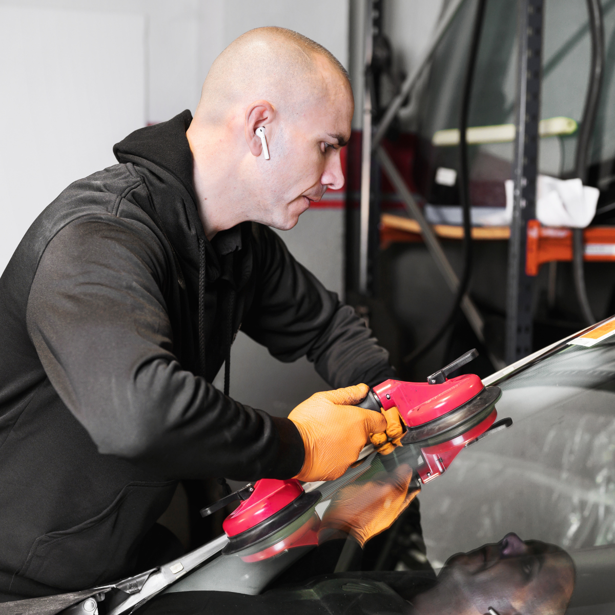 Certified technician performing auto glass replacement on a car in Georgetown, Texas