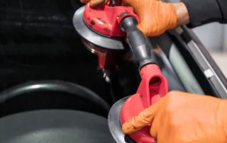 Step-by-Step Guide to Auto Glass Repair showing a technician fixing a windshield chip