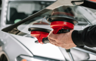 Repair or Replace Your Windshield - Technician Fixing a Chip
