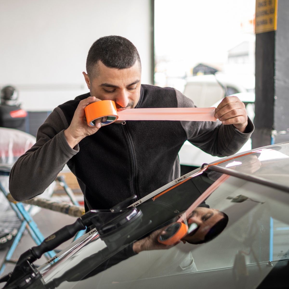 Cracked Windshield Repair vs Replacement Guide 2025 2 Cracked Windshield Repair vs Replacement technician working on car glass