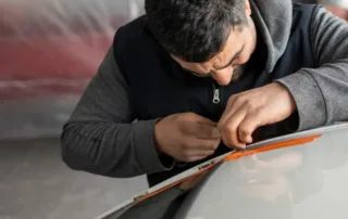 Auto Glass Repair Shops Near Me technician repairing windshield