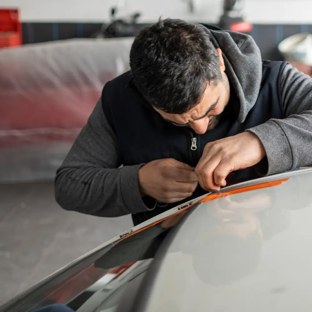 Auto Glass Repair Shops Near Me technician repairing windshield