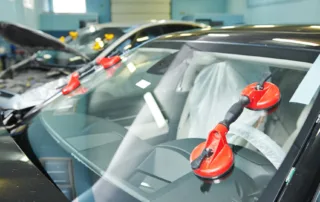 Expert Auto Glass Repair process showing professional resin injection technique for windshield chips and cracks