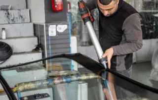 Solutions for Cracked Windshields — certified technician injecting resin into a chipped windshield
