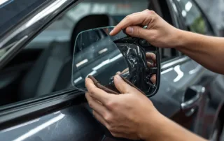 Certified technician performing professional side mirror replacement at Discount Auto Glass